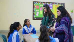 Students engaging with guests at the Open House