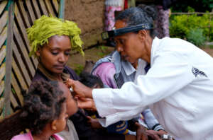 Aster applying the Ointment to treat trachoma