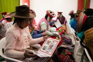 Promotoras studying their training books