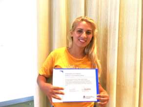 Paola with her certificate in Job Training