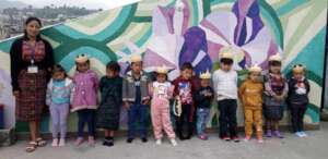 Preschool students standing with teacher