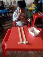 Student having fun with letter "T" pom pom maze