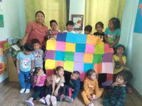 Preschool students with finished art project