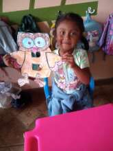 Student holding up letter "B" craft