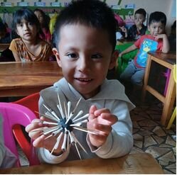 Student holding up sea urchin craft