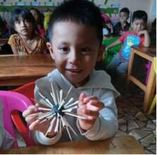 Student holding up sea urchin craft