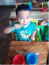 Student brushing teeth after snack