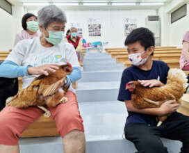 Grandma Hong holding a chicken