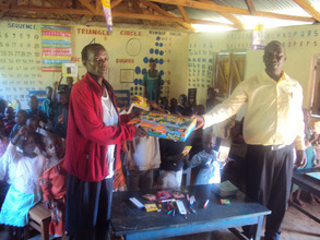 HWF staff handing over the materials to ECD teache