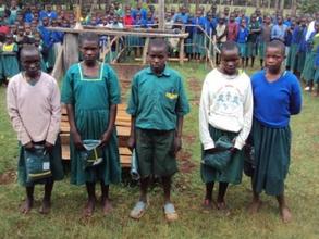 orphans in Nyambaria school receiving uniforms