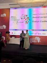Evelyn receiving Krutham Impact Trailblazer Award