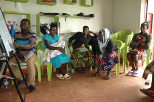 Facilitator training women on Day One