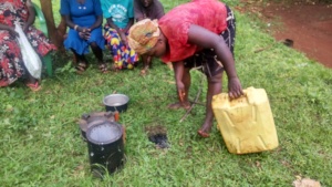 Atenyi putting off fire to produce biochar