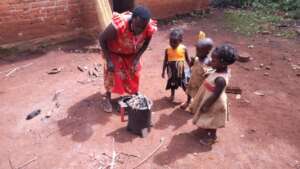 Rosemary lighting up her gasifier cookstove