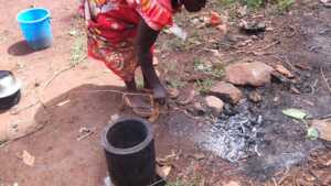 Rosemary extinguishes biochar made using her stove