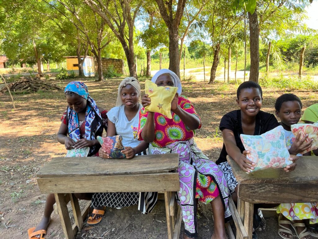 Ladies holding their Sanitary kits