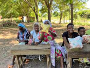 Ladies holding their Sanitary kits