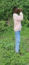 student looking for birds in the forest