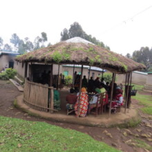 Women adult literacy classes under a bungalow