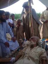 Dr Babar Ali tends to an elderly man