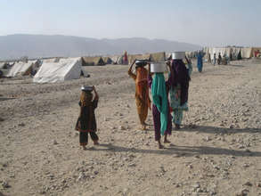 Women & children carrying water to tents...