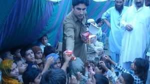 Distributing biscuits among the children