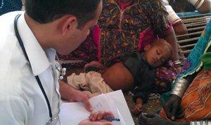 Physician treating pts in camp.