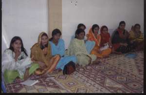 women in community meeting.