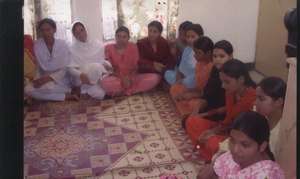 women in community meeting.