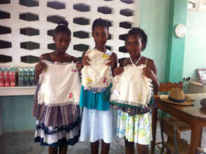 Marie, Saina and Jasmine with their embroidery.