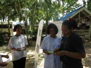 Nang explaining to two students