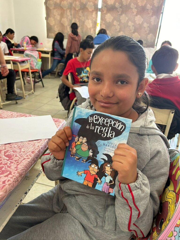 A girl receiving her book for the Big Read