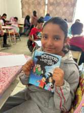 A girl receiving her book for the Big Read