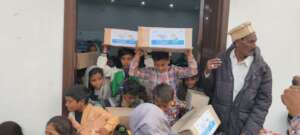 Children carrying their Happiness Packs