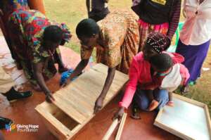 Women being trained in beehive construction