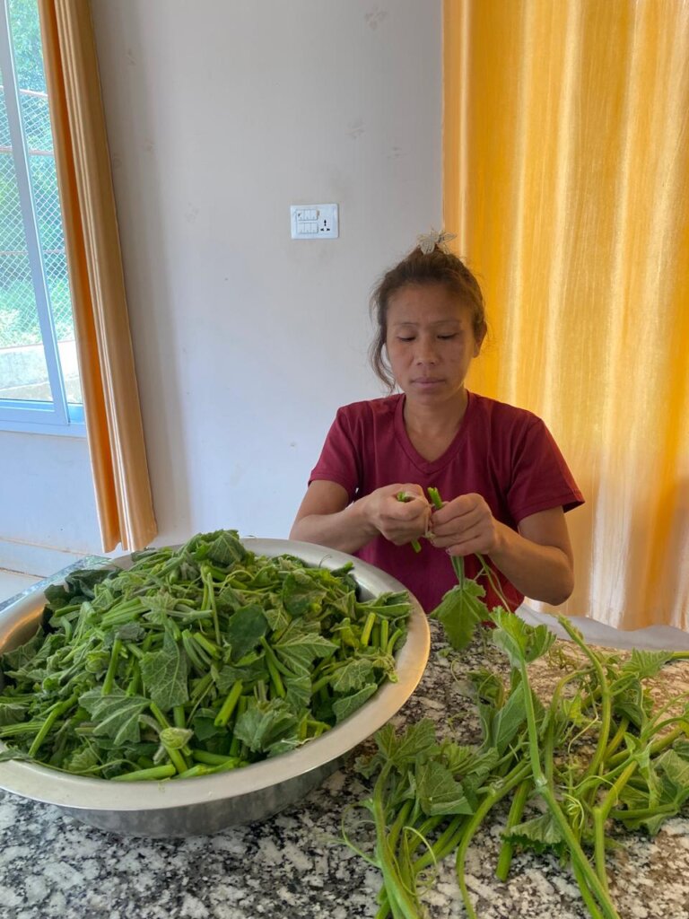 Beneficiary getting the vegetable ready for cookin