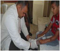 Young boy being fitted with a prosthetic leg