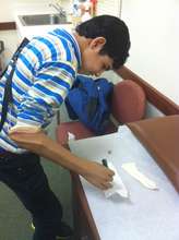 Mohammad writing with his new arm/hand