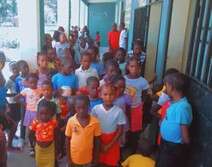 Children line up to get rice and beans