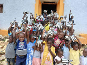 Children holding bags full of rice and beans
