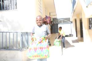 Distributing bags to thankful children