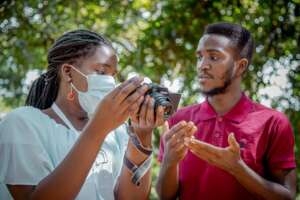 Daniel our volunteer in Uganda assisting a student