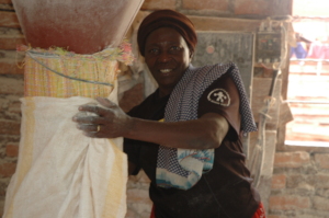 Margerat collecting milled cassava floor in a sack