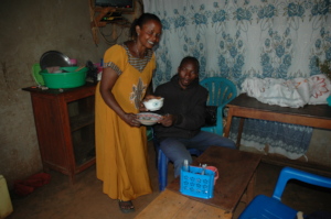 Edinansi serving customer in her local restaurant