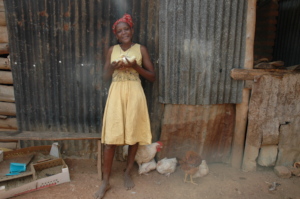 Eve standing infront of her chicken house