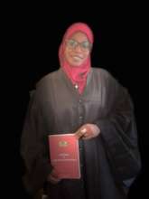 Aminatou at Court, with Penal Code book