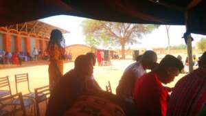 Teachers watching activities in the shade