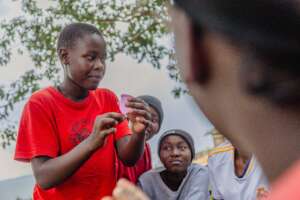Girl teaching peers about Menstrual cups