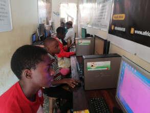 Photo of Children Learning Computer