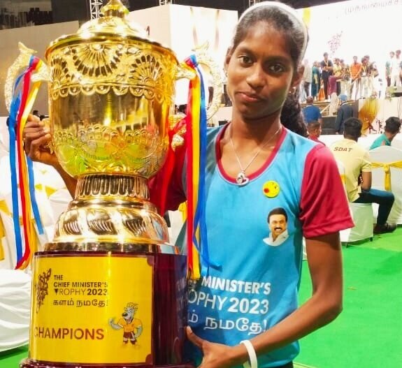 Nithya with the trophy she won.